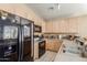 Functional kitchen featuring wooden cabinets, black appliances and ample counter space at 7808 W Palo Verde Dr, Glendale, AZ 85303