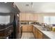 The kitchen features ample counter space, light wood cabinets, and black appliances at 7808 W Palo Verde Dr, Glendale, AZ 85303