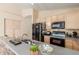 This kitchen features ample cabinet space, modern appliances, and a stone accent wall on the breakfast bar at 7808 W Palo Verde Dr, Glendale, AZ 85303