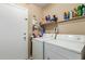 Laundry room with washer, dryer and storage shelf at 7808 W Palo Verde Dr, Glendale, AZ 85303