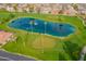 Scenic aerial view of a serene pond and lush golf course, perfect for a peaceful community setting at 8118 E Medina Ave, Mesa, AZ 85209