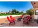 Backyard patio features red Adirondack chairs and a black iron fire pit at 8118 E Medina Ave, Mesa, AZ 85209
