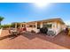 Spacious backyard patio with outdoor dining set, grill, and low maintenance landscaping at 8118 E Medina Ave, Mesa, AZ 85209