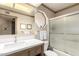 This bathroom includes a wood cabinet, white sink, and a shower with glass doors at 8118 E Medina Ave, Mesa, AZ 85209