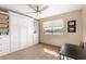 Bedroom features a large built-in cabinet, ceiling fan, and desk at 8118 E Medina Ave, Mesa, AZ 85209