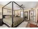 Primary bedroom features a large bed, ceiling fan, and view into the primary bathroom at 8118 E Medina Ave, Mesa, AZ 85209