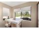 Bright breakfast nook with views of the golf course outside, with a white table and chairs at 8118 E Medina Ave, Mesa, AZ 85209