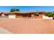 Traditional single-story brick home with an attached two-car garage and xeriscaped front yard for low maintenance at 8118 E Medina Ave, Mesa, AZ 85209