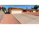 Charming single-story brick home featuring an attached two-car garage and a low maintenance front yard at 8118 E Medina Ave, Mesa, AZ 85209