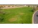 Scenic aerial view of the meticulously groomed golf course, showcasing its lush green fairways and challenging hole designs at 8118 E Medina Ave, Mesa, AZ 85209