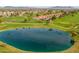Panoramic aerial view of the golf course with a scenic pond, showcasing the beautiful community and mountain backdrop at 8118 E Medina Ave, Mesa, AZ 85209