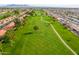Beautiful aerial view of the meticulously manicured golf course with mountain views and a serene atmosphere at 8118 E Medina Ave, Mesa, AZ 85209