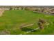 Expansive aerial view of the well-manicured golf course, highlighting its lush green landscape and the beautiful surrounding scenery at 8118 E Medina Ave, Mesa, AZ 85209