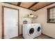 This laundry room includes a washer and dryer, and a window for natural light at 8118 E Medina Ave, Mesa, AZ 85209