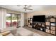 Bright living room featuring sliding glass doors to the back patio and a ceiling fan for added comfort at 8118 E Medina Ave, Mesa, AZ 85209