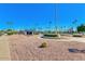 Community tennis courts on gravel with desert landscaping and blue sky at 8118 E Medina Ave, Mesa, AZ 85209