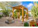 Beautiful backyard featuring desert landscaping, a dining pergola, and fire pit area ideal for outdoor entertaining at 8720 E Via De Dorado --, Scottsdale, AZ 85258