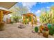 Scenic backyard featuring a pergola, desert landscaping, and fire pit seating area for outdoor enjoyment at 8720 E Via De Dorado --, Scottsdale, AZ 85258
