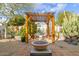 Charming backyard oasis with desert landscaping, a cozy dining pergola, and a inviting fire pit area at 8720 E Via De Dorado --, Scottsdale, AZ 85258
