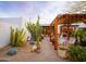 Enchanting backyard with desert landscaping, pergola, and outdoor seating at 8720 E Via De Dorado --, Scottsdale, AZ 85258