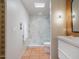 Well-lit bathroom featuring a tiled shower and a stylish vanity at 8720 E Via De Dorado --, Scottsdale, AZ 85258