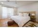 Bright bedroom featuring a woven headboard, white linens, and natural light, creating a relaxing ambiance at 8720 E Via De Dorado --, Scottsdale, AZ 85258