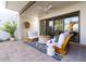 Relaxing covered patio with stylish seating, ceiling fan, and desert garden views at 8720 E Via De Dorado --, Scottsdale, AZ 85258