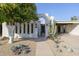 Inviting front entrance with modern architecture, desert landscaping, and a charming gated entryway at 8720 E Via De Dorado --, Scottsdale, AZ 85258