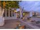 Elegant front gate and desert landscaping highlight the home's curb appeal at dusk at 8720 E Via De Dorado --, Scottsdale, AZ 85258