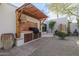 Outdoor kitchen featuring a built-in grill, rustic brick accents, and a tranquil desert garden backdrop at 8720 E Via De Dorado --, Scottsdale, AZ 85258