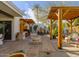 Inviting outdoor patio with a fire pit, wooden pergola, built in BBQ and lush desert landscaping at 8720 E Via De Dorado --, Scottsdale, AZ 85258