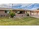 Charming single-story brick home with lush green lawn and covered front porch at 9441 W Long Hills Dr, Sun City, AZ 85351