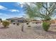 Large backyard featuring desert landscaping and a stone firepit area at 9952 W Jessie Ln, Peoria, AZ 85383