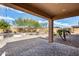 Backyard features a brick patio with a desert landscape and a built-in outdoor fire pit at 9952 W Jessie Ln, Peoria, AZ 85383