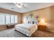 This bedroom features neutral walls, window shutters, and a ceiling fan above a neatly made bed at 9952 W Jessie Ln, Peoria, AZ 85383