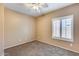 Bright bedroom featuring a ceiling fan, carpet, and a window with shutters at 9952 W Jessie Ln, Peoria, AZ 85383