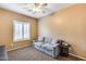 Cozy bedroom with carpet flooring, ceiling fan, and shuttered window at 9952 W Jessie Ln, Peoria, AZ 85383