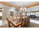 Inviting dining room with chandelier, seating for eight, with view to living areas at 9952 W Jessie Ln, Peoria, AZ 85383