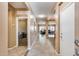 Inviting hallway with tile flooring and neutral paint, leading to various living spaces at 9952 W Jessie Ln, Peoria, AZ 85383