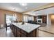 A gourmet kitchen features a large center island with white countertop and dark cabinetry at 9952 W Jessie Ln, Peoria, AZ 85383