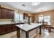 Open kitchen featuring an island with a marble countertop and seamless access to the dining area at 9952 W Jessie Ln, Peoria, AZ 85383