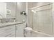 Bathroom featuring a granite countertop vanity, toilet, and glass enclosed shower at 10054 E Bell Rd, Scottsdale, AZ 85260