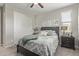 Bright bedroom featuring a ceiling fan, closet, and window with natural light at 10054 E Bell Rd, Scottsdale, AZ 85260