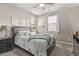 Comfortable bedroom featuring a ceiling fan, bedside table, and window with natural light at 10054 E Bell Rd, Scottsdale, AZ 85260