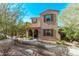 Two-story home with a front yard, desert landscaping, and brown shutters at 10054 E Bell Rd, Scottsdale, AZ 85260