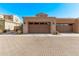 Exterior view of a three car garage on a sunny day at 10054 E Bell Rd, Scottsdale, AZ 85260