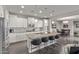 Bright kitchen with white cabinets, granite countertops, island seating, and open layout at 10054 E Bell Rd, Scottsdale, AZ 85260