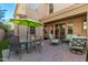 Charming outdoor patio featuring comfortable seating and a green umbrella for shade at 10054 E Bell Rd, Scottsdale, AZ 85260