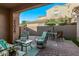 Cozy covered patio with comfortable seating and an outdoor dining area at 10054 E Bell Rd, Scottsdale, AZ 85260