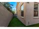 Narrow side yard with artificial grass for easy maintenance at 10054 E Bell Rd, Scottsdale, AZ 85260